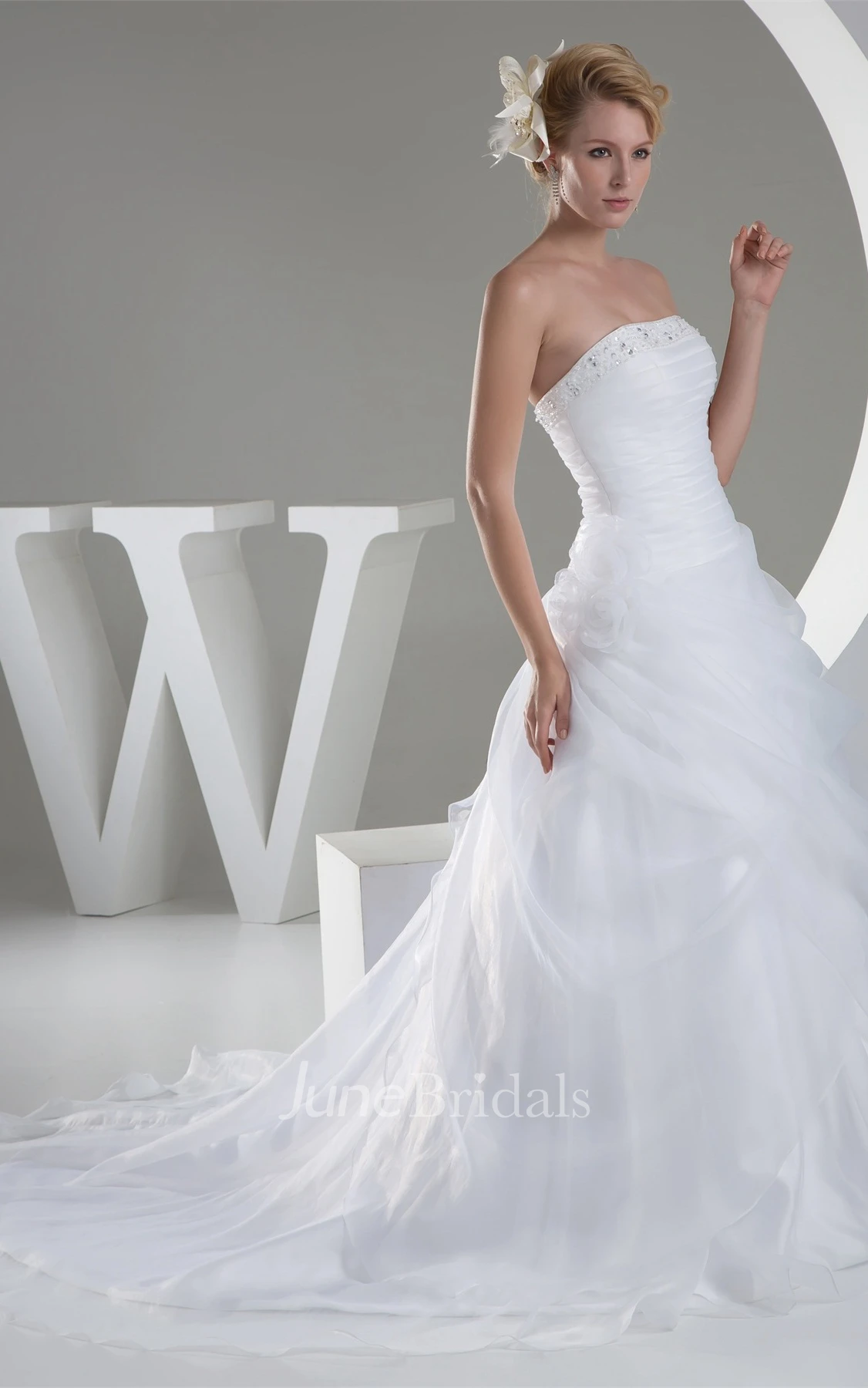 Strapless Ruched Jeweled Ball Gown with Flower and Ruffles